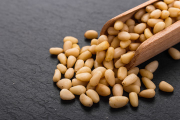 peeled pine nuts on a rustic background