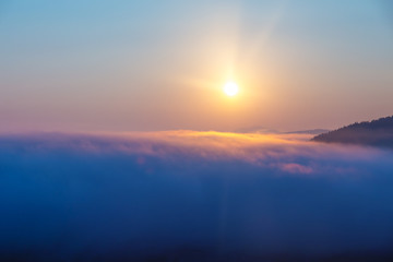 A beautiful morning landscape with sunshine and fog.