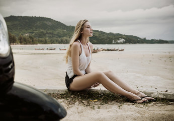 Fototapeta na wymiar Sensual young lady enjoying summer on a tropical beach