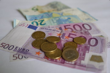 Euro banknotes and coins, selective focus