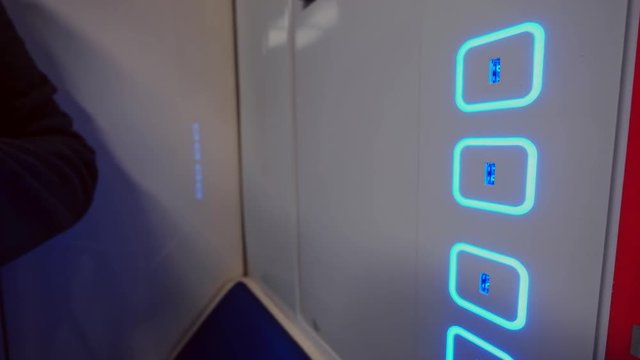 Male hand plug and unplug USB cable to the free charging port in modern subway train