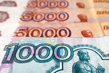 A bill of one thousand Russian rubles and five thousand Russian rubles in the background, close-up