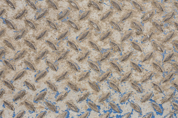 Industrial wallpaper of functional anti-slip metal diamond plate and rough raised surface pattern. Creative background macro photography of construction for catwalks, stairs, walkway.