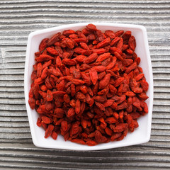 dried goji berries on a wooden rustic background