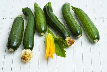 zucchini vegetables with flower on white wooden table