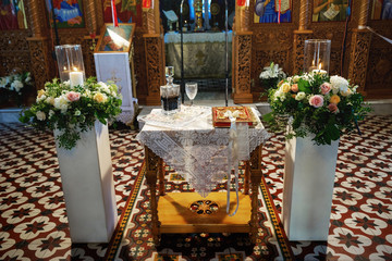 Wedding crowns, bible and wine glasses prepared for ceremony