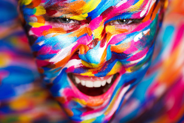 Portrait of the bright beautiful girl with art colorful make-up and bodyart