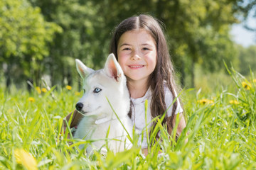 Little girl with husky puppy