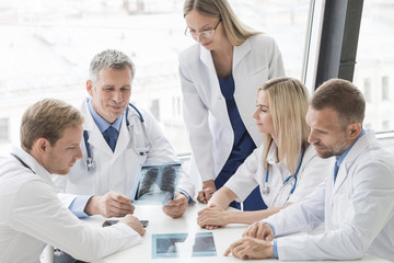 Group of doctors discuss x-ray