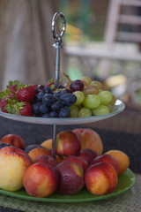 Fresh summer fruits. Organic and natural fruit on tray. Fresh grapes, cheaches, plums and strawberry. Healthy eating. Breakfast