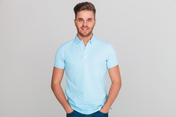 portrait of relaxed young man wearing light blue polo t-shirt