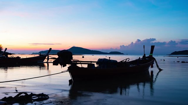 4-K time lapse of longtail fishing boats in the harbor phuket thailand