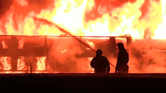 silhouettes of firefighters in night work