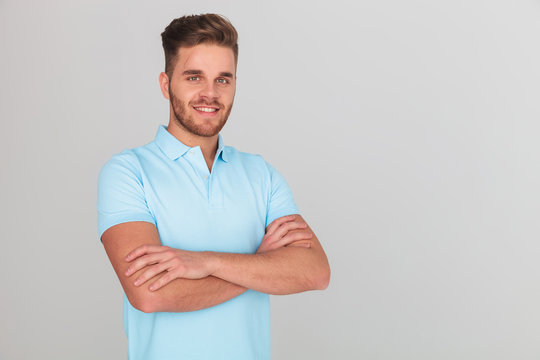 portrait of confident young man wearing light blue polo t-shirt
