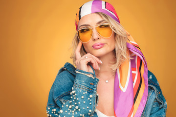 beautiful woman wearing colorful clothes looks to side while thinking
