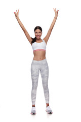 attractive young fit woman making peace sign with hands up