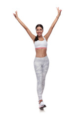excited fitness woman stepping while holding hands in the air