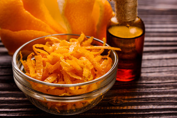 orange essential oil on a wooden background