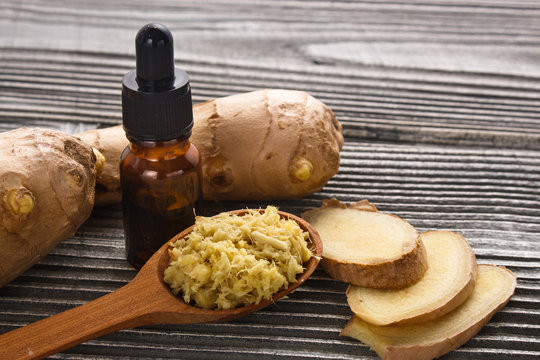 Ginger root essential oil on a dark background