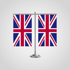 Table stand with flags of United Kingdom and United Kingdom.Two flag. Flag pole. Symbolizing the cooperation between the two countries. Table flags