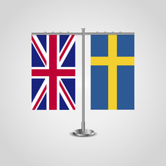 Table stand with flags of United Kingdom and Sweden.Two flag. Flag pole. Symbolizing the cooperation between the two countries. Table flags