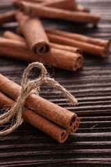 Cinnamon essential oil on a wooden background