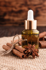 Cinnamon essential oil on a wooden background