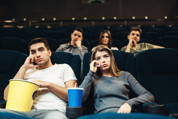 Boring film concept, couple watching movie