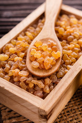 frankincense essential oil on a wooden background