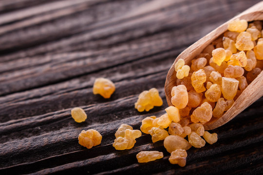 frankincense essential oil on a wooden background