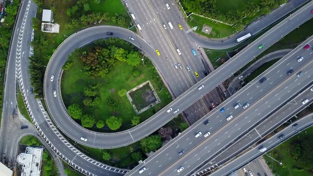4K. Aerial view of highway road interchange with busy urban traffic speeding on the road. Junction network of transportation in Bangkok, Thailand. taken by drone	