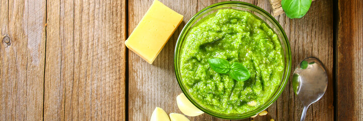 Homemade pesto sauce. Ingredients. Cheese, garlic, basil, pine nuts, olive oil on an old wooden...