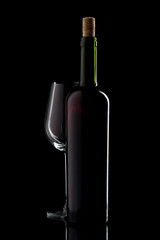Wine bottle with cork and empty glass on black isolated background