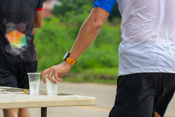 Marathon runner picking up water at service point