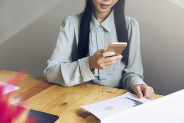 Working women use smartphones to control printer for print report via wifi or bluetooth.