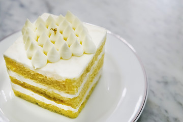 Coconut cake in white dish on marble table