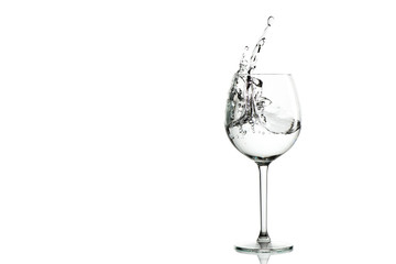 Clear water splashing in the wine glass. horizontal with space for text