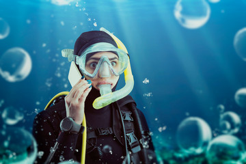 Obraz na płótnie Canvas Diver in wetsuit and diving gear, underwater view