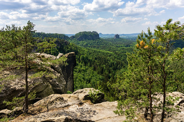 Fototapeta na wymiar Domerker vantage point in the Elbe Sandstone Mountains. Schrammsteine and Falkenstein rock formations in the background.