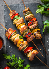 Grilled shish kebab with vegetables  on black.