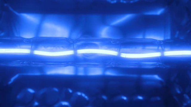 Flicker of a blue tungsten spiral of a halogen bulb.