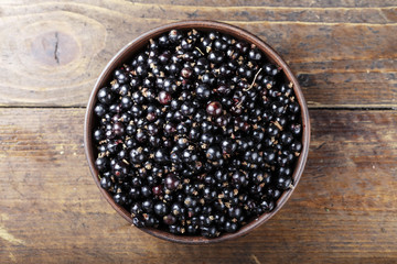 natural antioxidant fresh organic currant on a wooden background, space for text.