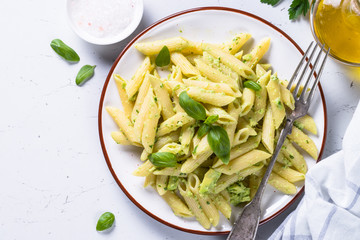 Vegan pasta penne with avocado and basil. 