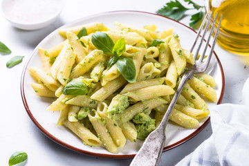 Vegan pasta penne with avocado and basil. 