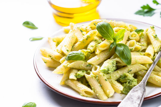 Vegan pasta penne with avocado and basil. 