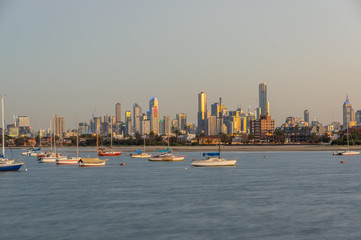 Sailing boats moored in St Kilda with the Melbourne skyline in the background.