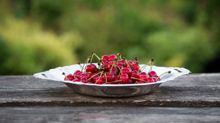 cherries in a metal plate outdoors