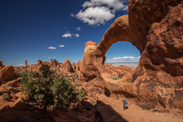 A family with baby son visits Arches National Park in Utah, USA