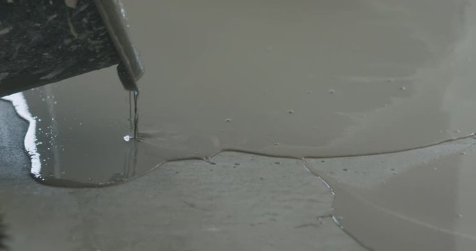 Slow motion pan of applying self leveling floor