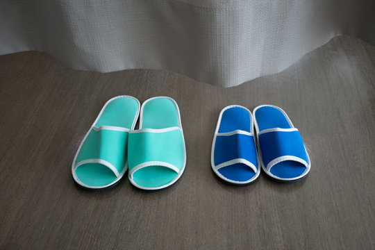 Blue And Green Slippers Behind Curtain In The Hospital